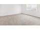 This is a bedroom featuring neutral carpet, a large window, and white walls at 345 S Alegria Ln, Casa Grande, AZ 85194