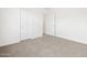 This bedroom has neutral carpet, white walls, and white doors at 345 S Alegria Ln, Casa Grande, AZ 85194