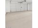 A spacious garage features a clean cement floor and a modern white garage door at 345 S Alegria Ln, Casa Grande, AZ 85194
