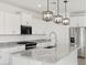 Bright kitchen featuring white cabinets, stainless steel appliances, and a large island with granite countertops at 345 S Alegria Ln, Casa Grande, AZ 85194