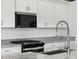 Close up of kitchen showing the stove, microwave, countertops, cabinets, and faucet at 345 S Alegria Ln, Casa Grande, AZ 85194
