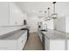 Bright kitchen featuring white cabinets, stainless steel appliances, and a large island with granite countertops at 345 S Alegria Ln, Casa Grande, AZ 85194