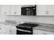 Close up of kitchen showing the stove, microwave, countertops, and cabinets at 345 S Alegria Ln, Casa Grande, AZ 85194