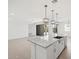 Bright kitchen featuring white cabinets, stainless steel appliances, and a large island with granite countertops at 345 S Alegria Ln, Casa Grande, AZ 85194