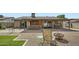 Inviting backyard with covered patio, built-in grill, seating area, and mature landscaping at 3514 W Charleston Ave, Glendale, AZ 85308