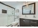 Modern bathroom featuring a glass shower, tile backsplash, and vanity with marble countertop at 3514 W Charleston Ave, Glendale, AZ 85308