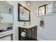 Stylish bathroom featuring a dark vanity, modern lighting, and a window for natural light at 3514 W Charleston Ave, Glendale, AZ 85308