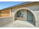 Close up of the front entrance featuring an arched doorway and desert landscaping at 3514 W Charleston Ave, Glendale, AZ 85308