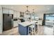 Modern kitchen with stainless steel appliances, a large island, and pendant lighting at 3514 W Charleston Ave, Glendale, AZ 85308