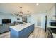 Bright kitchen and open living area with a large island and contemporary finishes at 3514 W Charleston Ave, Glendale, AZ 85308