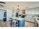 Modern kitchen features a large island with seating, sleek appliances and ample counter space at 3514 W Charleston Ave, Glendale, AZ 85308