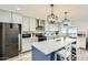 Stylish kitchen features stainless appliances, a center island, and sleek white cabinetry at 3514 W Charleston Ave, Glendale, AZ 85308
