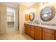 Bathroom showcasing double sinks with granite counters and a large walk-in closet at 36600 N Cave Creek Rd # 17D, Cave Creek, AZ 85331