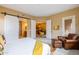 Bedroom with sliding barn doors, a seating area, and an open view to the living spaces at 36600 N Cave Creek Rd # 17D, Cave Creek, AZ 85331