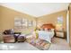Bright bedroom featuring a comfortable chair, rug, and scenic view window at 36600 N Cave Creek Rd # 17D, Cave Creek, AZ 85331