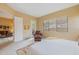 Bedroom featuring a chair, exterior doors, view window, and neutral color scheme at 36600 N Cave Creek Rd # 17D, Cave Creek, AZ 85331