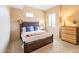 Well-lit bedroom featuring a unique bed frame, window views, and comfortable carpet at 36600 N Cave Creek Rd # 17D, Cave Creek, AZ 85331
