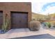 Double garage doors featuring decorative hardware and desert landscaping surrounding the entrance at 36600 N Cave Creek Rd # 17D, Cave Creek, AZ 85331