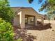 Backyard featuring a covered patio and desert landscaping with mature trees and shrubs at 3918 E Carson Rd, Phoenix, AZ 85042