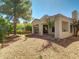 A backyard with a patio, desert landscaping, and mature trees for shade at 3918 E Carson Rd, Phoenix, AZ 85042