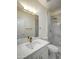 Bright bathroom featuring a white vanity, a white quartz countertop, and a marble tiled shower at 3918 E Carson Rd, Phoenix, AZ 85042
