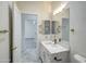 Bright bathroom featuring a white vanity with quartz countertop, and a large framed mirror at 3918 E Carson Rd, Phoenix, AZ 85042