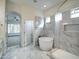 Bright bathroom showcasing a standalone tub next to a beautifully tiled shower, complemented by a luxurious stone floor at 3918 E Carson Rd, Phoenix, AZ 85042