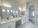 Bright bathroom featuring double vanity with white counters, sleek sinks, and a spacious walk-in shower at 3918 E Carson Rd, Phoenix, AZ 85042