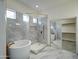 This bathroom features a stand alone tub, glass shower and walk in closet at 3918 E Carson Rd, Phoenix, AZ 85042