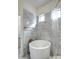 Bright bathroom showcasing a standalone tub next to a beautifully tiled shower, complemented by a luxurious stone floor at 3918 E Carson Rd, Phoenix, AZ 85042