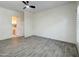 This bedroom features wood look ceramic tile flooring, a ceiling fan and lots of natural light at 3918 E Carson Rd, Phoenix, AZ 85042