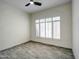 Bedroom with tile floors, white walls, large windows, and a ceiling fan at 3918 E Carson Rd, Phoenix, AZ 85042