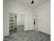 This bedroom features wood look ceramic tile flooring and a mirrored closet with built in shelving at 3918 E Carson Rd, Phoenix, AZ 85042