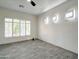 This bedroom features wood look ceramic tile flooring, a ceiling fan and lots of natural light at 3918 E Carson Rd, Phoenix, AZ 85042
