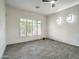 This bedroom features wood look ceramic tile flooring, a ceiling fan and lots of natural light at 3918 E Carson Rd, Phoenix, AZ 85042