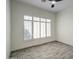 Bedroom with tile floors, white walls, large windows, and a ceiling fan at 3918 E Carson Rd, Phoenix, AZ 85042