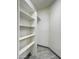 This walk-in closet features built-in shelves and wood look ceramic tile flooring at 3918 E Carson Rd, Phoenix, AZ 85042
