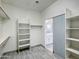 Walk-in closet with custom shelving and light gray wood-style tile floors at 3918 E Carson Rd, Phoenix, AZ 85042