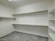 Walk-in closet featuring custom shelving and wood-style tile floors at 3918 E Carson Rd, Phoenix, AZ 85042