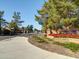 Community entrance, 'The Pines', with landscaped flowerbeds at 3918 E Carson Rd, Phoenix, AZ 85042