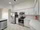 Well-equipped kitchen featuring stainless steel appliances and white cabinetry at 3918 E Carson Rd, Phoenix, AZ 85042