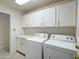 Laundry room featuring a white countertop, ample storage, and a white washer and dryer at 3918 E Carson Rd, Phoenix, AZ 85042