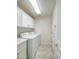 Laundry room featuring a white countertop, ample storage, and a white washer and dryer at 3918 E Carson Rd, Phoenix, AZ 85042