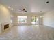 Spacious living room with tile flooring, fireplace, and a sliding glass door to the patio at 3918 E Carson Rd, Phoenix, AZ 85042
