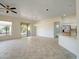 Open-concept living area featuring tile floors, a ceiling fan, and access to the kitchen at 3918 E Carson Rd, Phoenix, AZ 85042