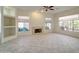 Bright and open living room with a fireplace, built-in shelves, and neutral tile flooring at 3918 E Carson Rd, Phoenix, AZ 85042