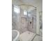 This marble shower features a glass door and shower head with wand at 3918 E Carson Rd, Phoenix, AZ 85042