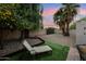 Private backyard oasis featuring lush greenery, gravel accents, and a relaxing lounge chair under a shade tree at 4130 N 4Th Ave, Phoenix, AZ 85013