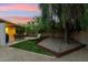Outdoor backyard featuring a lounging area, mature tree, and rock feature, creating a relaxed ambiance at 4130 N 4Th Ave, Phoenix, AZ 85013