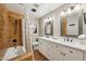 Well-lit bathroom with double vanity, wood-look shower, and sleek fixtures, creating a spa-like ambiance at 4130 N 4Th Ave, Phoenix, AZ 85013